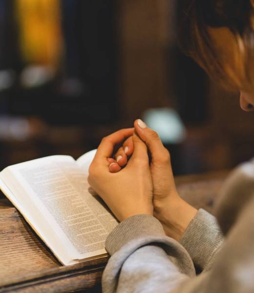 Christian woman reading bible in an ancient Catholic temple. Reading the Holy Bible in temple Christian woman reading bible in an ancient Catholic temple. Reading the Holy Bible in temple. Concept for faith, spirituality and religion. Peace, hope, dreams concept